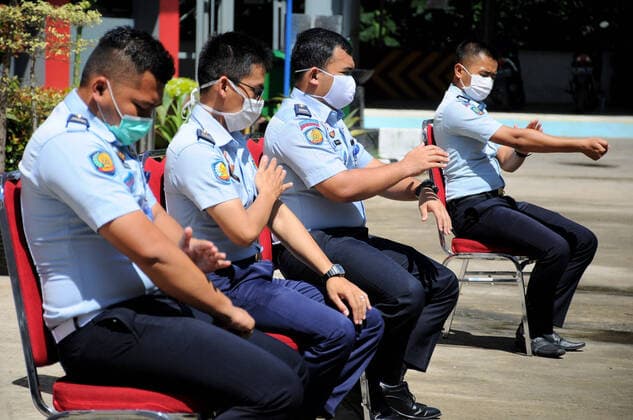 April 7, 2020, Depok, Indonesia: Officers of prison wardens are basking and doing gymnastics in the sun in the courtyard of the Class 1 Detention Center. they do every day to strengthen the body s immunity and avoid disease and viruses. Depok Indonesia  - ZUMAPris 20200407_mda_r173_065 Copyright: xDasrilxRoszandix
