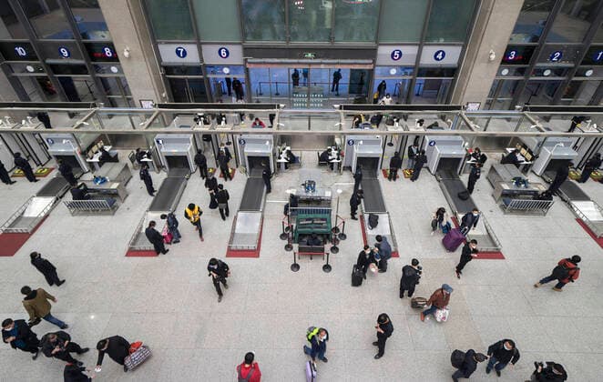 (200408) -- BEIJING, April 8, 2020 -- Passengers enter Wuchang Railway Station in Wuhan, central China s Hubei Province, late April 7, 2020. Wuhan on Wednesday lifted outbound travel restrictions, after almost 11 weeks of lockdown to stem the spread of COVID-19. ) XINHUA PHOTOS OF THE DAY FeixMaohua 