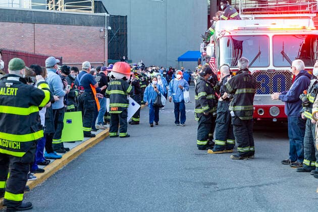 NY: Nassau County first responders salute medics Nassau County first responders line up to salute heroes from front lines of COVID-19 pandemic at North Shore University Hospital where medical personnel leaves day shift Manhasset New York United States Copyright: LevxRadin