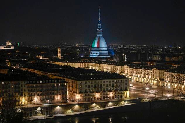 Turin. Intesa SanPaolo and Mole Antonelliana skyscraper with the Italian flag during the lockdown for Covid19 in the photo: Mole Antonelliana  Copyright: xRiccardoxGiordanox xIPAx xFotosickix