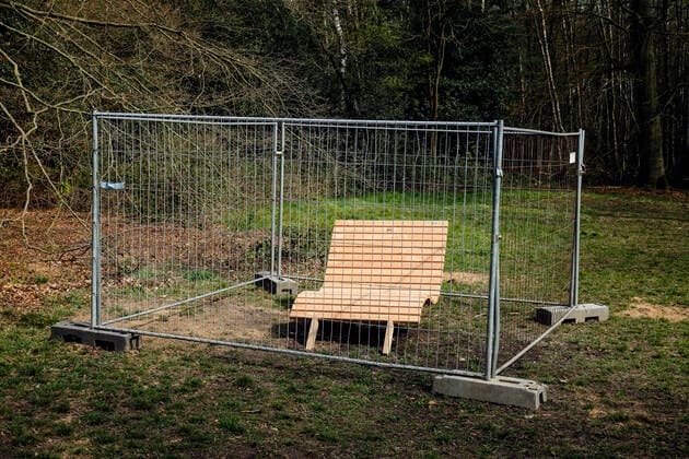 07 04 2020, Duisburg, Ruhr Area, North Rhine-Westphalia, Germany Park bench in Duisburgs municipal forest in times of the corona crisis, fenced off by a construction fence, with contact ban Duisburg North Rhine-Westphalia Germany