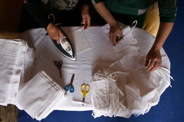 SOCHI, RUSSIA - APRIL 8, 2020: Ironing fabric for face masks. The Barsegyans receive materials from the Sochi city hall, sew face masks and give them to volunteers and healthcare workers attending patients under quarantine. Dmitry Feoktistov TASS  TS0D4D99