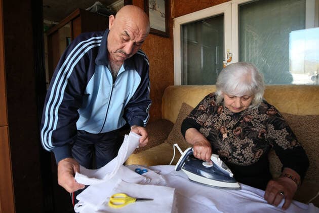 SOCHI, RUSSIA - APRIL 8, 2020: Gamlet and Asmik Barsegyan ironing fabric for face masks. The Barsegyans receive materials from the Sochi city hall, sew face masks and give them to volunteers and healthcare workers attending patients under quarantine. Dmitry Feoktistov TASS  TS0D4D9F