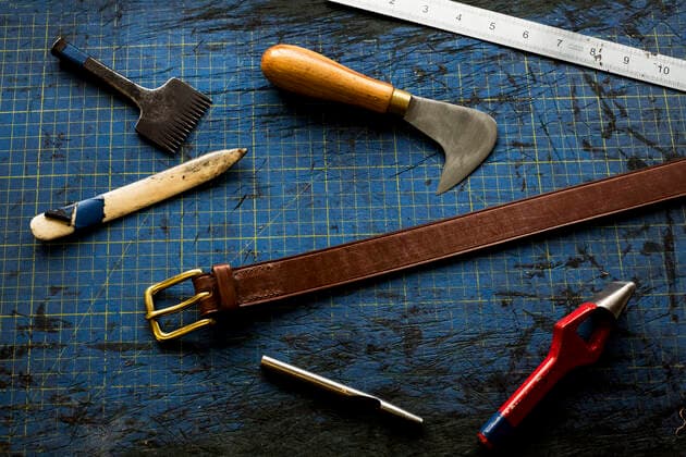High angle close up of selection of saddle making hand tools. High angle close up of selection of saddle making hand tools.,Farm  60692