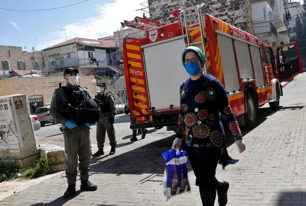 (200408) -- JERUSALEM, April 8, 2020 (Xinhua) -- Israeli police officers wearing face masks are seen on a street in Mea Shearim neighborhood in Jerusalem, on April 8, 2020. Israel reported six new death cases from the novel coronavirus, bringing the death toll to 71, the state s Ministry of Health said Wednesday. The ministry added that a total of 9,404 people in Israel were tested positive for COVID-19 so far. (Photo by Gil Cohen Magen Xinhua) MIDEAST-JERUSALEM-COVID-19-CURFEW 