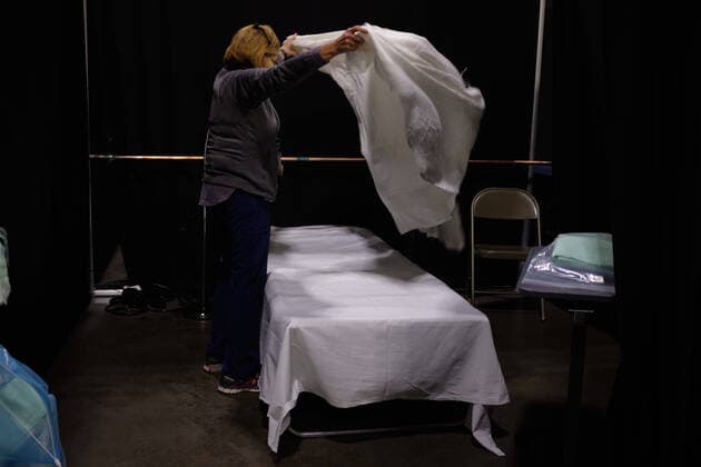 April 8, 2020, Worcester, Massachusetts, US: The building of the FEMA COVID-19 Field Hosiptal in collaboration with Umass Memorial Hospital at the DCU Center in Worcester, Massachusetts. The 250 bed hospital with have COVID-19 positive patients that are too sick to be home, but not sick enough for an ICU. The hospital is staffed by Umass Memorial Hospital. A nurse makes a bed for one of he first patients to arrive. Worcester US - ZUMAd211 20200408_zap_d211_005 Copyright: xAllisonxDinnerx
