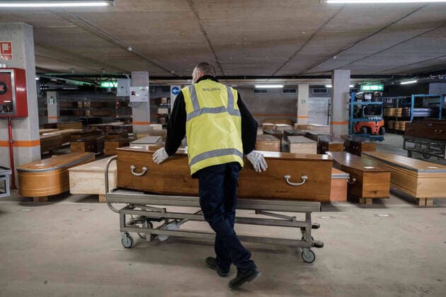 April 8, 2020, Barcelona, Spain: A worker moves coffins of people killed by coronavirus in a parking lot turned into a morgue...Coronavirus outbreak in Spain has already killed 14,659 people. The large number of deaths has forced Eurocoffin, the main coffin factory in Catalonia, to triple its production, from 50 to 150 coffins per day. Isolation and quarantine prevent family members from gettting infected or infect others. In Spain today, the pandemic leaves numbers of 146,690 infected and 48,021 recovered. Barcelona Spain - ZUMAs197 20200408_zaa_s197_157 Copyright: xPabloxMiranzox