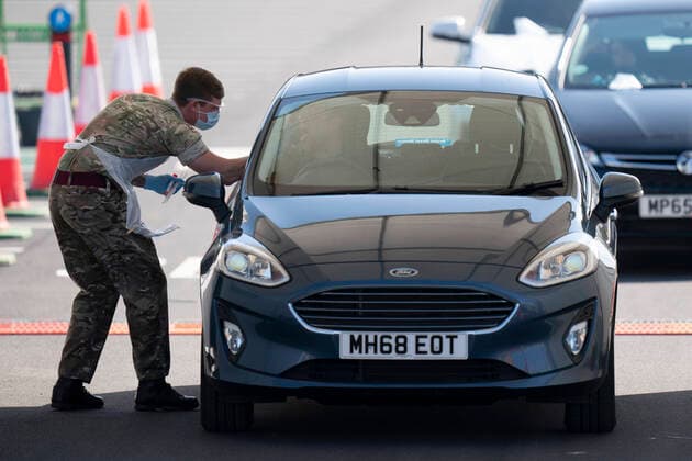(200408) -- MANCHESTER (BRITAIN), April 8, 2020 -- A soldier takes a sample from a person in a car at a drive-through COVID-19 testing facility in Manchester, Britain, on April 8, 2020. As of Wednesday morning, the number of confirmed COVID-19 cases in Britain hit 60,733, up 5,492 in the past 24 hours, said the Department of Health and Social Care. (Photo by Xinhua) BRITAIN-MANCHESTER-COVID-19-DRIVE THROUGH TEST JonxSuper
