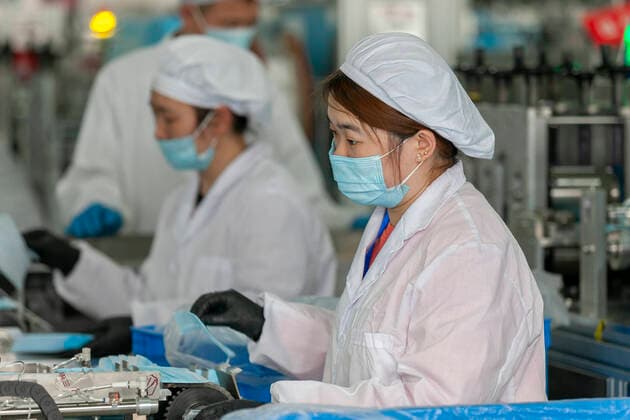(200409) -- SHANGHAI, April 9, 2020 -- Workers make protective masks at a mask plant of Chinese underwear brand Threegun Group in Shanghai, east China, April 8, 2020. The mask production of the company has kicked into high gear recently with the daily output reaching one million pieces. (Photo by Xinhua) CHINA-SHANGHAI-MASKS PRODUCTION (CN) WangxXiang 