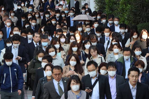 April 9, 2020, Tokyo, Japan - Commueters are heading to their office in Tokyo on Thursday, April 9, 2020. Japanese Prime Minister Shinzo Abe declared a state of emergency to fight outbreak of the new coronavirus on April 7.  (125181404)