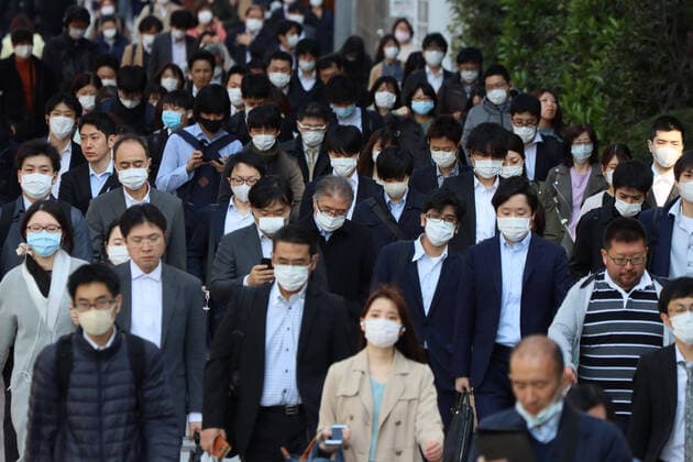 April 9, 2020, Tokyo, Japan - Commueters are heading to their office in Tokyo on Thursday, April 9, 2020. Japanese Prime Minister Shinzo Abe declared a state of emergency to fight outbreak of the new coronavirus on April 7.  (125181408)