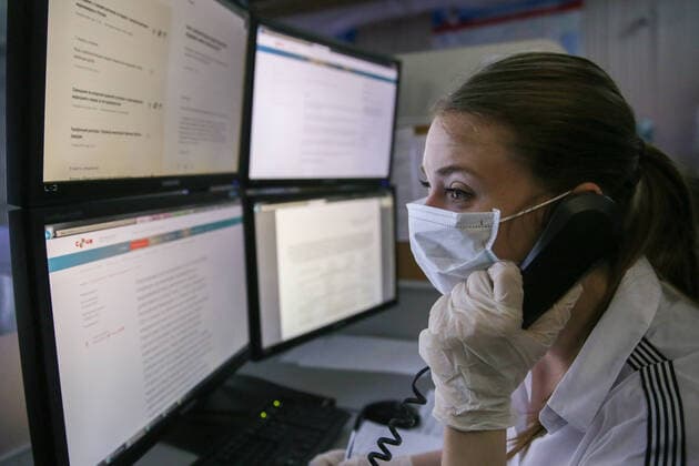 SOCHI, RUSSIA - APRIL 9, 2020: An operator speaking on a phone at a public safety answering point on the COVID-19 pandemic. Dmitry Feoktistov TASS  TS0D4EC4