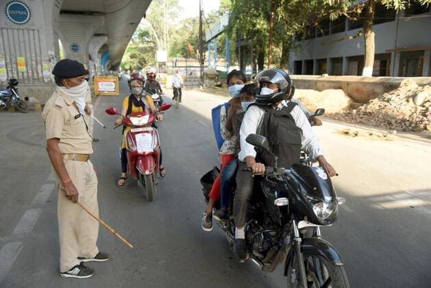 PATNA, INDIA APRIL 7: Police personnel screen for identity cards during day fourteen of the 21 day nationwide lockdown to curb the spread of coronavirus, at Bailey road, on April 7, 2020 in Patna, India. (Photo by Santosh Kumar Hindustan Times ) India Goes Into 21 Day Lockdown Due To Coronavirus COVID 19