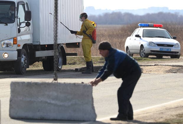 RYAZAN REGION, RUSSIA - APRIL 9, 2020: Placing a concrete obstacle at a checkpoint at an entrance to the village of Zaokskoye where several cases of the COVID-19 coronavirus infection were registered. The villages of Zaokskoye and Korostovo, Ryazan Region, have been put into lockdown from April 8 till April 22, 2020, to prevent the spread of the virus. Despite the novel coronavirus pandemic residents of the villages had been going to Moscow to sell dairy products, which, according to the local residents, led to the outbreak in the villages. Alexander Ryumin TASS  TS0D5088