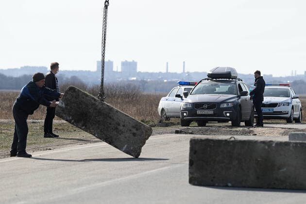 RYAZAN REGION, RUSSIA - APRIL 9, 2020: Placing a concrete obstacle at a checkpoint at an entrance to the village of Zaokskoye where several cases of the COVID-19 coronavirus infection were registered. The villages of Zaokskoye and Korostovo, Ryazan Region, have been put into lockdown from April 8 till April 22, 2020, to prevent the spread of the virus. Despite the novel coronavirus pandemic residents of the villages had been going to Moscow to sell dairy products, which, according to the local residents, led to the outbreak in the villages. Alexander Ryumin TASS  TS0D5089