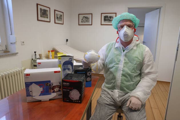 Coronavirus, mask deficiency in German medical practices, doctor, medical practice, family doctor, doctor with mouth protection, FFP2 mask, respiratory protection mask with filter, and disposable protective goggles, safety goggles,
