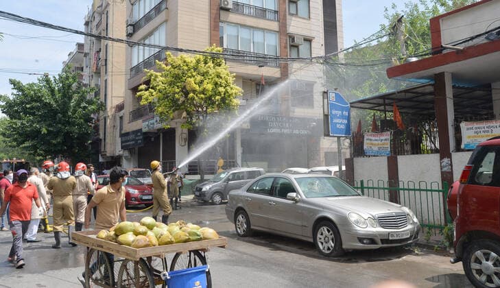 India: Disinfecting residential area against coronavirus A Fireman wearing protective gear sprays disinfectant in a residential area in New Delhi, India as the Covid-19 Corona Virus cases continue to go up daily. New Delhi India Copyright: SondeepxShankar