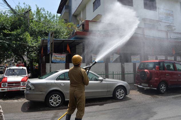 India: Disinfecting residential area against coronavirus A Fireman wearing protective gear sprays disinfectant in a residential area in New Delhi, India as the Covid-19 Corona Virus cases continue to go up daily. New Delhi India Copyright: SondeepxShankar