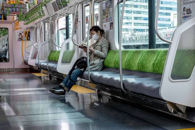 April 9, 2020, Tokyo, Japan: A woman wearing a face mask for protection reads on a almost empty JR train..The Japan government declared a state of emergency to cover Tokyo, Osaka, also covers Saitama, Kanagawa, Chiba, Hyogo and Fukuoka prefectures on the 7th April and will continue until at least May 6. Tokyo governor Yuriko Koike has asked residents to self-isolate as COVID-19 coronavirus spreads. Tokyo Japan - ZUMAs197 20200409_zaa_s197_073 Copyright: xViolaxKamx