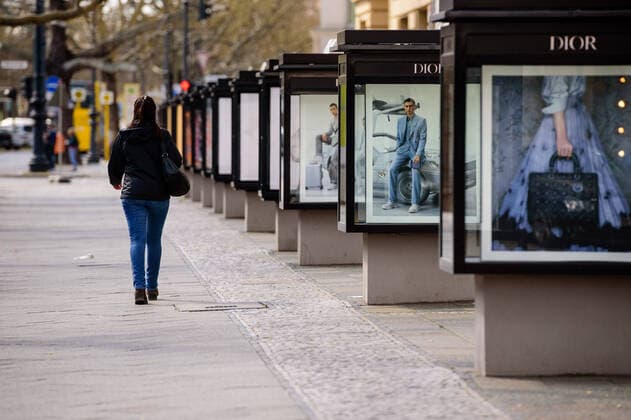 April 9, 2020, Berlin, Berlin, Germany: A woman can be seen walking alone past advertising displays. German Federal Government and the heads of government of the federal states adopted guidelines for further restricting social contacts in the public sector in view of the corona epidemic in Germany. Currently, meetings of more than two people are not allowed. As far as possible, a minimum distance of 1.5 meters must be maintained. Violations are punishable by a fine. Berlin Germany - ZUMAs172 20200409_zap_s172_006 Copyright: xJanxScheunertx