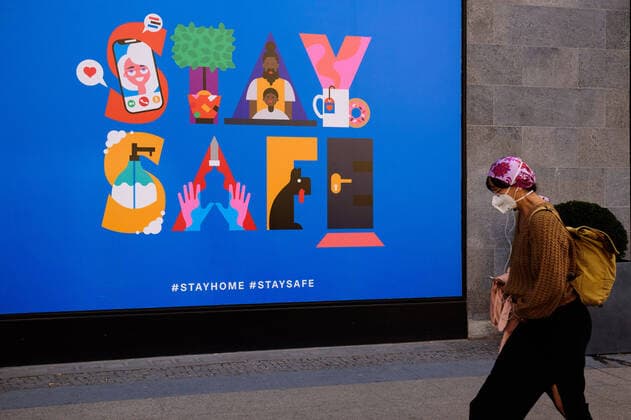 April 9, 2020, Berlin, Berlin, Germany: A woman wearing a protective breathing mask can be seen in front of a blue sign saying STAY SAFE . German Federal Government and the heads of government of the federal states adopted guidelines for further restricting social contacts in the public sector in view of the corona epidemic in Germany. Currently, meetings of more than two people are not allowed. As far as possible, a minimum distance of 1.5 meters must be maintained. Violations are punishable by a fine. Berlin Germany - ZUMAs172 20200409_zap_s172_020 Copyright: xJanxScheunertx