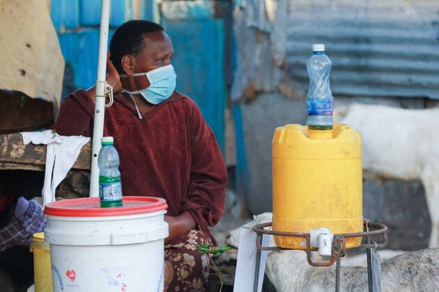 April 8, 2020, Nairobi, Kenya: A woman wearing a face mask as a precaution against the spread of coronavirus offers water and soap to make sure people moving on the street wash their hands..These items have been on demand after the Government directive on wearing face masks while in public places. On Monday, April 6, Kenyan President Uhuru Kenyatta announced a 21-day cessation of movement in and out of Nairobi and the counties of Kilifi, Kwale, and Mombasa due to the spread of COVID-19 in these regions. This followed a night curfew (7pm to 5am) that had been imposed just days before. Nairobi Kenya - ZUMAs197 20200408_zaa_s197_181 Copyright: xBonifacexMuthonix