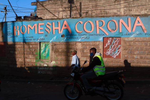April 8, 2020, Nairobi, Kenya: A Boda boda rider in Mathare Slum rides past a painted wall with the Swahili slogan Komesha Corona which means Stop Corona..These items have been on demand after the Government directive on wearing face masks while in public places. On Monday, April 6, Kenyan President Uhuru Kenyatta announced a 21-day cessation of movement in and out of Nairobi and the counties of Kilifi, Kwale, and Mombasa due to the spread of COVID-19 in these regions. This followed a night curfew (7pm to 5am) that had been imposed just days before. Nairobi Kenya - ZUMAs197 20200408_zaa_s197_186 Copyright: xBonifacexMuthonix