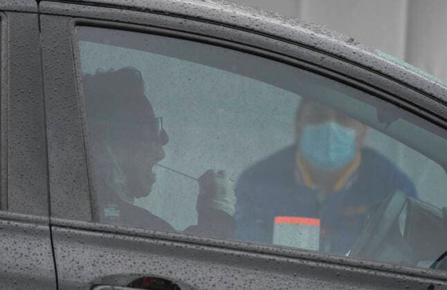 April 9, 2020, Los Angeles, California, U.S: A woman swabs her mouth during a drive-through COVID-19 testing in a parking lot of the Rose Bowl in Pasadena, California on Thursday, April 9, 2020. Los Angeles U.S. - ZUMAc68_ 20200409_zaf_c68_003 Copyright: xRingoxChiux
