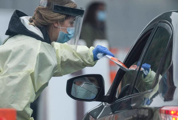 April 9, 2020, Los Angeles, California, U.S: A medical staff wearing a mask and protective face shield gives a test kit to a motorist in a car during a drive-through COVID-19 testing in a parking lot of the Rose Bowl in Pasadena, California on Thursday, April 9, 2020. Los Angeles U.S. - ZUMAc68_ 20200409_zaf_c68_011 Copyright: xRingoxChiux
