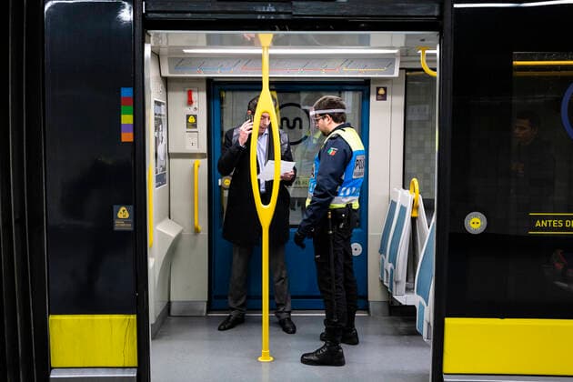 April 9, 2020, Porto, Portugal: A police officer checks a passengers documentation in a metro do porto..From April 9th until April 13th, Easter period, the movement of people outside the municipality of residence is prohibited, and people will only be able to leave their municipality of residence if they have proof of the working entity. Within this period of time the police will inspect highways, buses and the metro, this is done to prevent the spread of coronavirus in Porto. Porto Portugal - ZUMAs197 20200409_zaa_s197_108 Copyright: xRitaxFrancax
