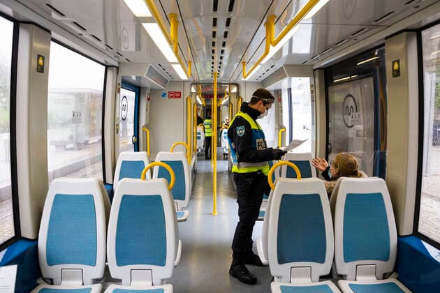 April 9, 2020, Porto, Portugal: A police officer checks a passengers documentation in a metro do porto..From April 9th until April 13th, Easter period, the movement of people outside the municipality of residence is prohibited, and people will only be able to leave their municipality of residence if they have proof of the working entity. Within this period of time the police will inspect highways, buses and the metro, this is done to prevent the spread of coronavirus in Porto. Porto Portugal - ZUMAs197 20200409_zaa_s197_117 Copyright: xRitaxFrancax
