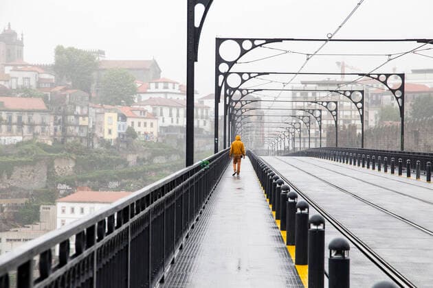 April 9, 2020, Porto, Portugal: A man walks on an empty D. Luis bridge, a bridge that connects the city of Vila Nova de Gaia and Porto..From April 9th until April 13th, Easter period, the movement of people outside the municipality of residence is prohibited, and people will only be able to leave their municipality of residence if they have proof of the working entity. Within this period of time the police will inspect highways, buses and the metro, this is done to prevent the spread of coronavirus in Porto. Porto Portugal - ZUMAs197 20200409_zaa_s197_118 Copyright: xRitaxFrancax