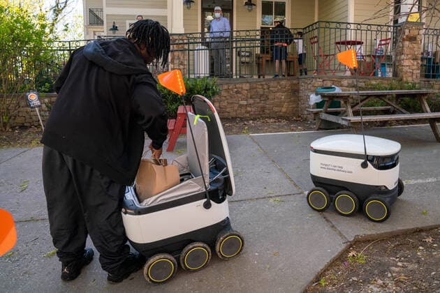 April 9, 2020: Anthony, a Broad Branch Market employee places a custom order of groceries into Starship Technologies robot for delivery in Washington, DC on Thursday, April 9, 2020. Broad Branch Market has closed their store due to COVID 19 and operating with phone-in orders, purchasing small items at the window and using Starship Technologies for robotic deliveries of food to the neighborhood. - ZUMAc206 20200409_zap_c206_006 Copyright: xKenxCedenox