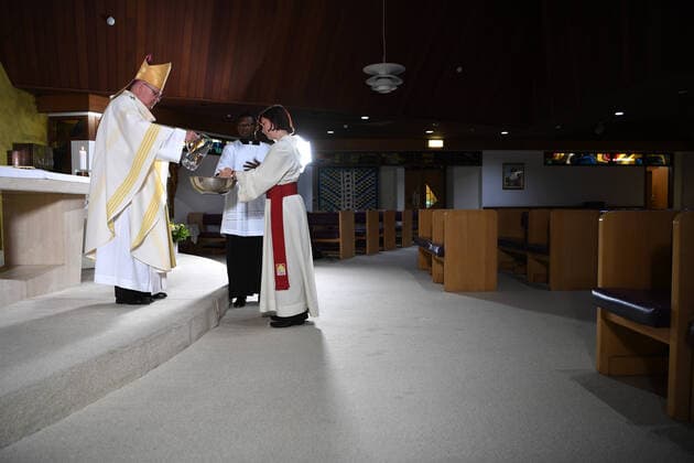 HOLY THURSDAY MASS COVID-19, Brisbane s Catholic archbishop Mark Coleridge (left) performs a ritual during a Holy Thursday mass, which is being broadcasted online, in an empty chapel at St Vincent s Private Hospital in Brisbane, Thursday, April 9, 2020. The hospital has made preparations to take in coronavirus victims if needed. ( NO ARCHIVING, EDITORIAL USE ONLY, NO USE IN BOOKS WITHOUT CONSENT BRISBANE QLD AUSTRALIA  Copyright: xDANxPELEDx 20200409001462629751