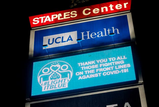 April 9, 2020, Los Angeles, California, U.S: The LIGHTITBLUE message: Ã¢â‚¬oeTHANK YOU TO ALL THOSE FIGHTING ON THE FRONT LINES AGAINST COVID-19!Ã¢â‚¬Â. is displayed on a screen outside Staples Center in solidarity with the hospital workers and first responders fighting COVID-19, Thursday, April 9, 2020, in Los Angeles. Over 150 sites all over the U.S. lighted up blue tonight at 8pm local time in solidarity with the hospital workers and first responders fighting COVID-19. Los Angeles U.S. - ZUMAc68_ 20200409_zaf_c68_047 Copyright: xRingoxChiux