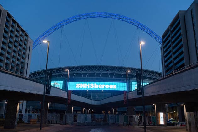 (200410) -- LONDON, April 10, 2020 (Xinhua) -- Wembley Stadium is lit blue to honour the efforts of NHS(National Health Service) workers fighting the coronavirus outbreak in northwest London, Britain on April 9, 2020. (Photo by Ray Tang Xinhua) BRITAIN-LONDON-COVID-19-NHS 
