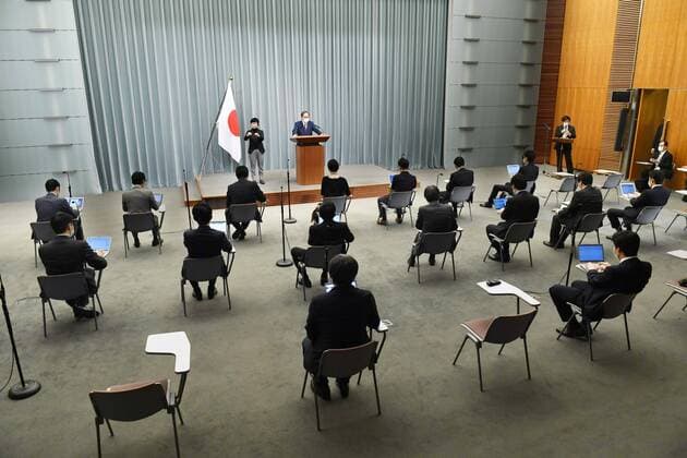 New coronavirus Reporters sit at a distance from one another during a press conference by Chief Cabinet Secretary Yoshihide Suga in Tokyo on April 10, 2020, due to the coronavirus pandemic. 