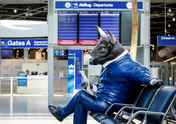 09 04 2020, Duesseldorf, North Rhine-Westphalia, Germany Duesseldorf Airport, deserted departure hall in times of the corona crisis, a bull advertising figure was glued on a mouthguard, a bullish Boersian with mouthguard reads the Handelsblatt Duesseldorf North Rhine-Westphalia Germany