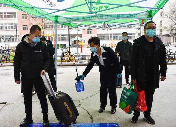 (200410) -- TAIYUAN, April 10, 2020 -- A staff member disinfects the luggage of a student at Taiyuan University of Technology in Taiyuan, north China s Shanxi Province, April 10, 2020. The first batch of graduating students and post-graduates and doctorial students with research tasks in Shanxi resumed classes from Friday. ) CHINA-SHANXI-UNIVERSITY-CLASS-RESUMPTION (CN) ChaixTing 