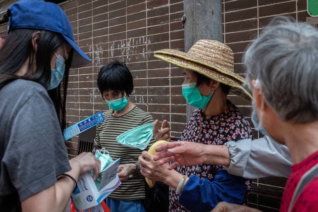 April 10, 2020, Hong Kong, China: A group of elderly women receive surgical masks from a volunteer as a preventive measure against the spread of Coronavirus..As the coronavirus pandemic worsens, thousands of Hong Kong residents who live in cramped coffin homes or homeless situation are struggling to adjust to their new reality. Coronavirus cases in Hong Kong are close to the 1,000 mark. Hong Kong China - ZUMAs197 20200410_zaa_s197_020 Copyright: xSOPAxImagesx