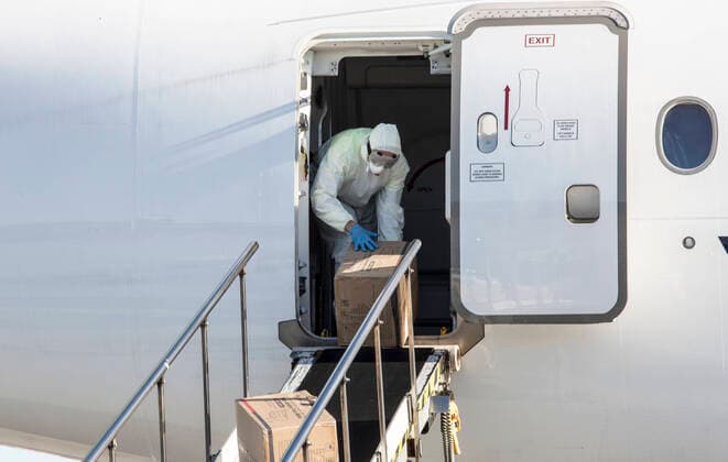 (200410) -- RIGA, April 10, 2020 -- A worker unloads personal protection equipment (PPE) from China to help curb the spread of the novel coronavirus disease (COVID-19), in Riga, Latvia on April 10, 2020. (Photo by Xinhua) LATVIA-RIGA-COVID-19-PPE EdijsxPalens 