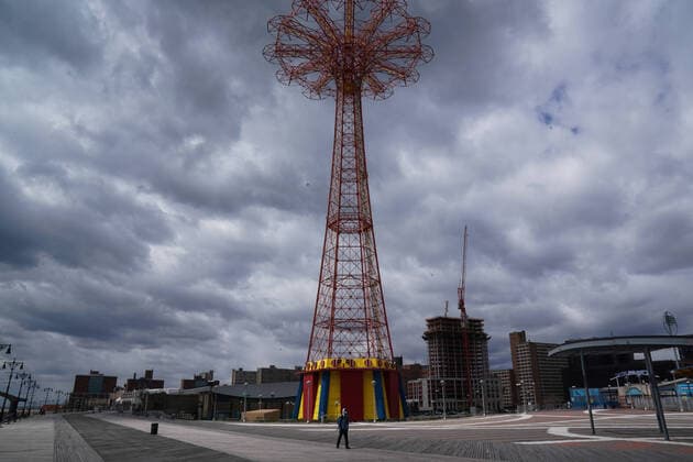 April 10, 2020, New York, NY, USA: A man walks on the deserted boardwalk past the Parachute Jump, a defunct amusement ride in the Coney Island section of the Borough of Brooklyn on April 10, 2020 in New York. New York USA - ZUMAb148 20200410_zap_b148_119 Copyright: xBryanxSmithx