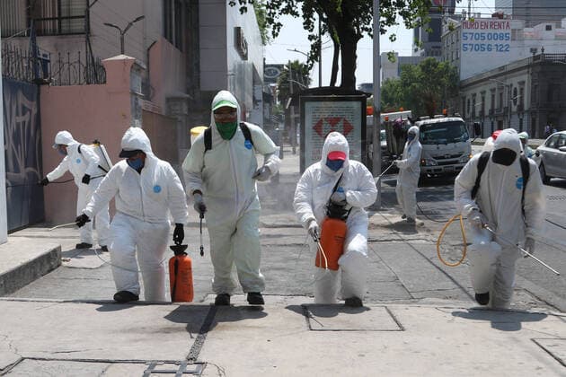 Mexico: Coronavirus prevention Health worker wears protective gear while spraying disinfectant solution on the ground outside the Buenavista train station as a measure security to combat the spread of the SARS COV-2 which causes the disease COVID-19. For editorial use only. Please contact your Local office representative for commercial use. **Mandatory Credit** Mexico City Mexico Copyright: IsmaelxRosas