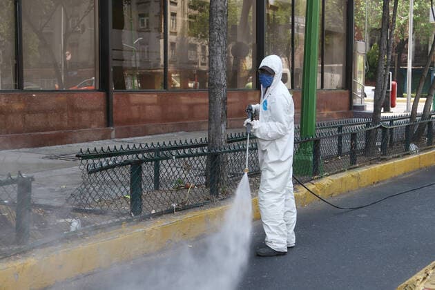 Mexico: Coronavirus prevention Health worker wears protective gear while spraying disinfectant solution on the ground outside the Buenavista train station as a measure security to combat the spread of the SARS COV-2 which causes the disease COVID-19. For editorial use only. Please contact your Local office representative for commercial use. **Mandatory Credit** Mexico City Mexico Copyright: IsmaelxRosas