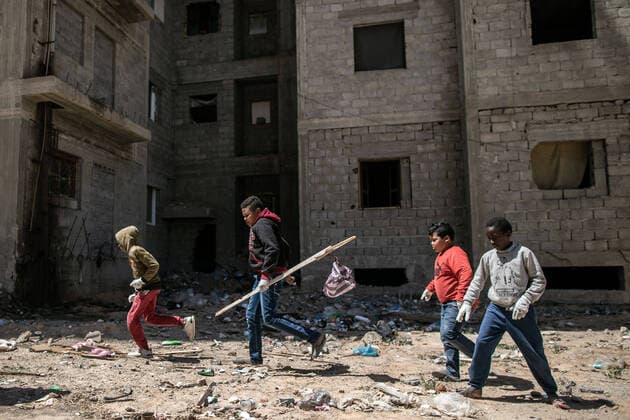 (200410) -- TRIPOLI, April 10, 2020 -- Displaced children play outside a building complex under construction in Tripoli, Libya, on April 10, 2020. The UN Support Mission in Libya (UNSMIL) has documented at least 356 civilian deaths and 329 injuries since the outbreak of a conflict in April 2019 between the eastern-based army and the UN-backed government in and around Tripoli. Since the beginning of the conflict, nearly 150,000 people in and around Tripoli have been forced to flee their homes, with 345,000 civilians remaining in frontline areas and some 749,000 living in conflict-affected areas, according to UNSMIL. (Photo by Xinhua) LIBYA-TRIPOLI-DISPLACED PEOPLE AmruxSalahuddien