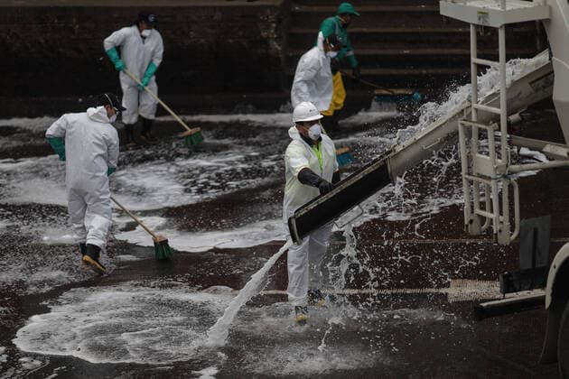 (200411) -- BOGOTA, April 11, 2020 (Xinhua) -- Members of staff disinfect a farm product market amid coronavirus pandemic in Bogota, Colombia, April 10, 2020. (Photo by Jhon Paz Xinhua) COLOMBIA-BOGOTA-COVID-19 