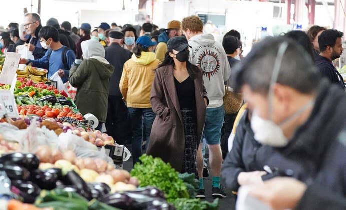 AUSTRALIA CORONAVIRUS COVID-19, People shop at the Queen Victoria Market while wearing face masks as a preventive measure against the spread of novel coronavirus COVID-19 in Melbourne, Saturday, April 11, 2020. Authorities have said social distancing and isolation measures could still remain in place for the next six months. A shutdown of non-essential services is in effect Australia wide in a bid to slow the spread of the coronavirus (COVID-19) disease. ( NO ARCHIVING, EDITORIAL USE ONLY, NO USE IN BOOKS WITHOUT CONSENT MELBOURNE VIC AUSTRALIA  Copyright: xSCOTTxBARBOURx 20200411001463005587