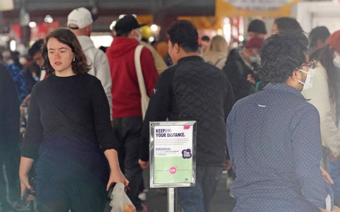 AUSTRALIA CORONAVIRUS COVID-19, People shop at the Queen Victoria Market while wearing face masks as a preventive measure against the spread of novel coronavirus COVID-19 in Melbourne, Saturday, April 11, 2020. Authorities have said social distancing and isolation measures could still remain in place for the next six months. A shutdown of non-essential services is in effect Australia wide in a bid to slow the spread of the coronavirus (COVID-19) disease. ( NO ARCHIVING, EDITORIAL USE ONLY, NO USE IN BOOKS WITHOUT CONSENT MELBOURNE VIC AUSTRALIA  Copyright: xSCOTTxBARBOURx 20200411001463005959