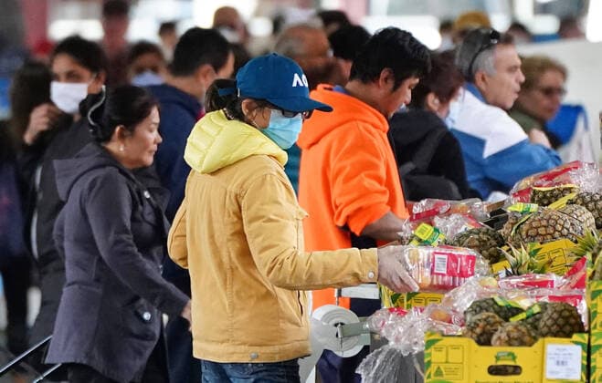 AUSTRALIA CORONAVIRUS COVID-19, People shop at the Queen Victoria Market while wearing face masks as a preventive measure against the spread of novel coronavirus COVID-19 in Melbourne, Saturday, April 11, 2020. Authorities have said social distancing and isolation measures could still remain in place for the next six months. A shutdown of non-essential services is in effect Australia wide in a bid to slow the spread of the coronavirus (COVID-19) disease. ( NO ARCHIVING, EDITORIAL USE ONLY, NO USE IN BOOKS WITHOUT CONSENT MELBOURNE VIC AUSTRALIA  Copyright: xSCOTTxBARBOURx 20200411001463007081