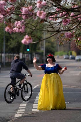 (200411) -- STOCKPORT, April 11, 2020 -- Rebecca Williamson, a girl dressed in Snow White costumes, cheers up people amid the COVID-19 pandemic in Stockport near Manchester, Britain, on April 10, 2020. Rebecca, one of those who dressed as comic books or fairytale characters, attempted to cheer up people in the public during the epidemic outbreak. (Photo by Xinhua) UK-STOCKPORT-COVID-19-SNOW WHITE JonxSuper 